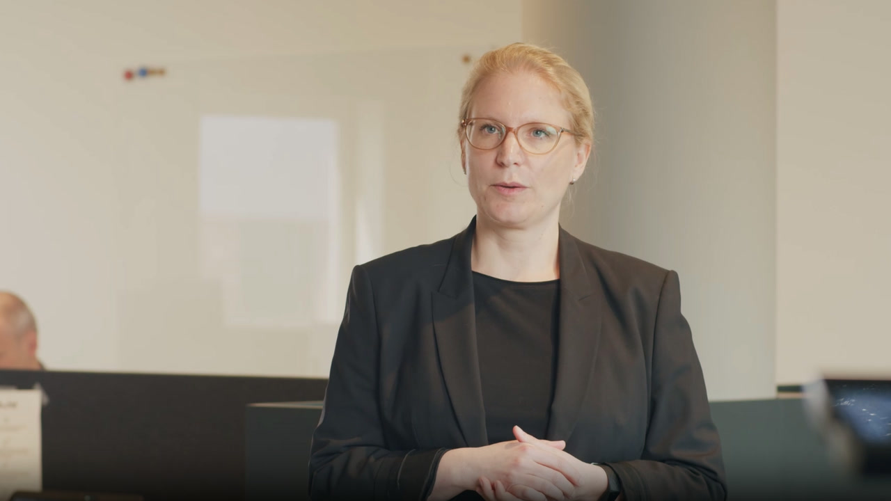 Joëlle Stokkel speaking during a video interview in a modern office setting